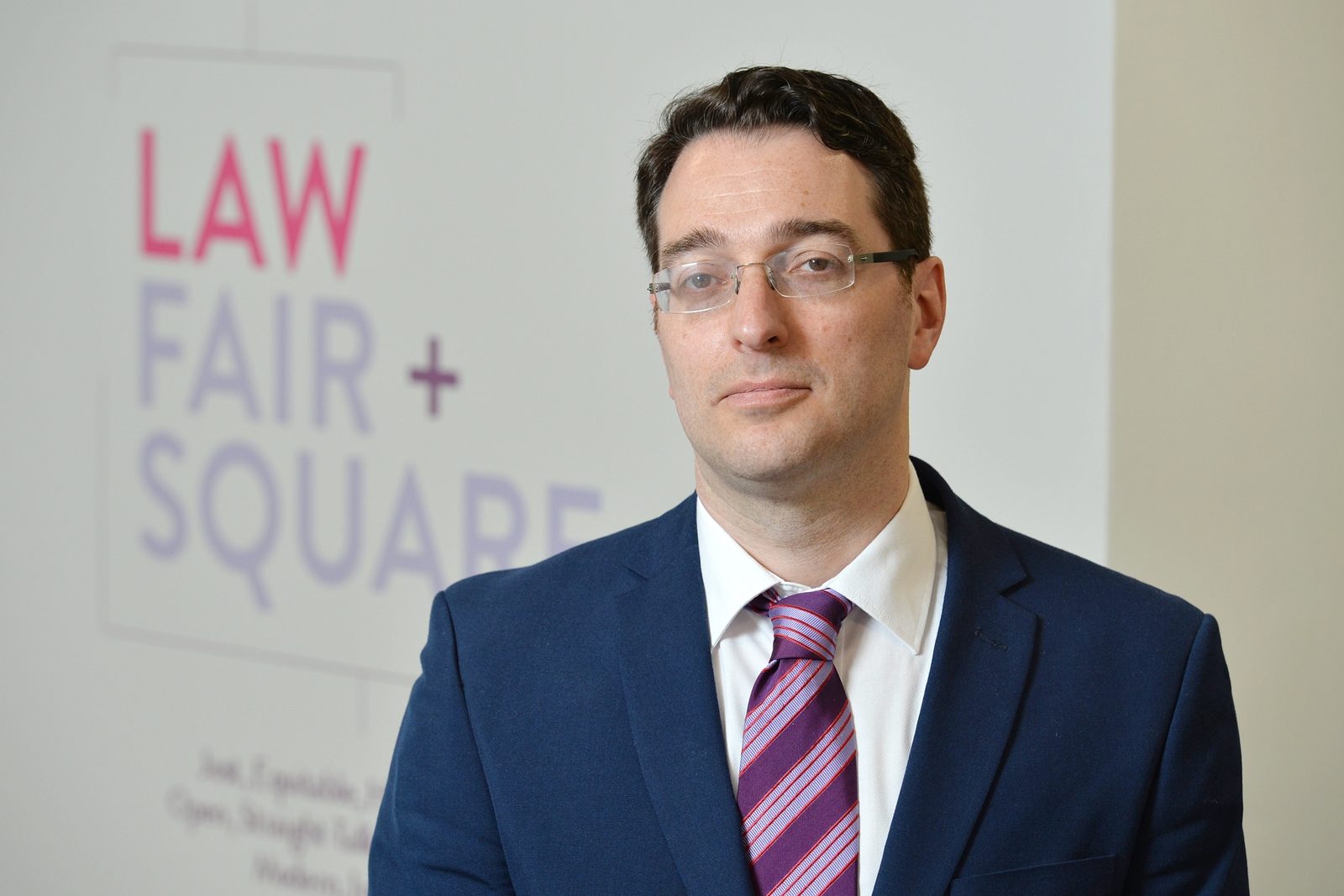 James Austin, employment law partner at LCF Law, in front of the firm's Law Fair + Square sign
