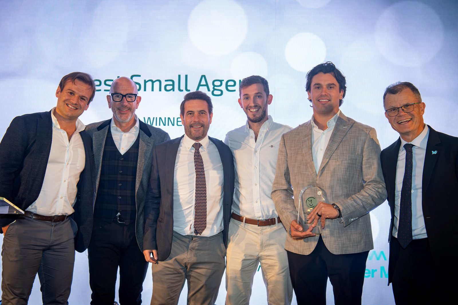 Josh Kitson of sponsor Walker Morris, Jonathan Morgan, Ian Darley, Martin Bowman and Tobias Duczenko of Zenko City Living, and host Dominic Holland, with the Best Small Agent award